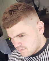 A boring, strandard fade. 00 fade with texture on top. Bit of sea salt spray and powder to style it.