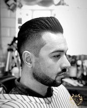 Big Poppa fadeed styled pomp with reversed skin faded beard shape up