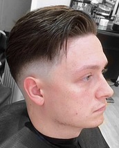 Hanging over Skin fade with the hair cut to hang over to the side