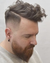 hard part fade Hard parting with a clean fade leaving a curly natural top