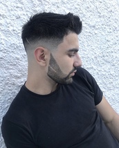Harley slice through the beard A skin fade quiff with a sharp beard shape and scratch