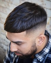 heavy modern crop Bold skin fade on sides and back with textured and point cut on top.This look take