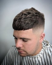 Heavy texture Heavily textured crop following the natural direction of the hair with a skinfade