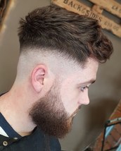 Skin Heavily weighted skinfade with a beard taper, and textured scissor cut on top