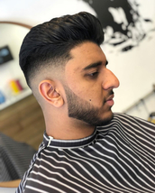 Skin fade push back Scissor cut top with a sweep back blowdry. Skin faded sides and beard.