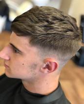 Skin Fade with texture Sharp skin fade with texture on top to allow movement.