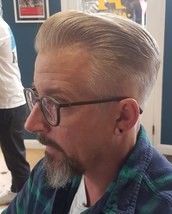 Slicked back Length left in the front and slicked back without product for a natural finish