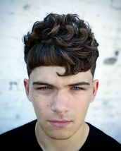 The hook Defusing natural curls on the top flowing down towards a two faced fringe, hooking on side 