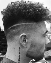Urban curls Clipper fade from Zero to 1.5 to temple line in a diagonal section from behind the ear. 