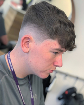 Wavey Skin fade, natural waves through the top with no product used.